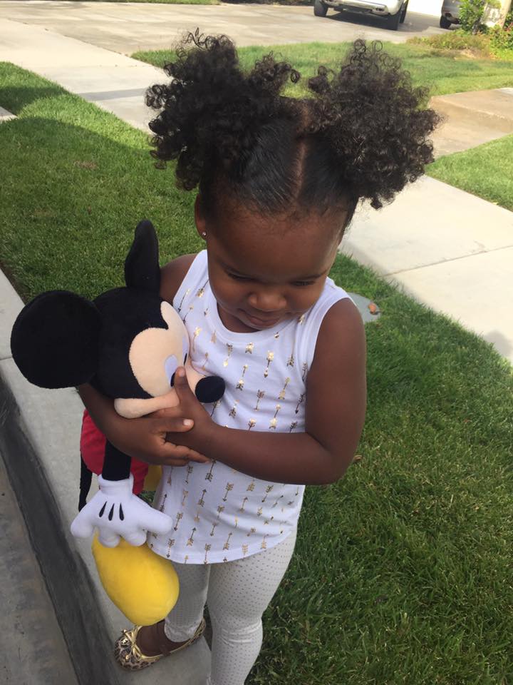 Black girl with her Mickey Toy