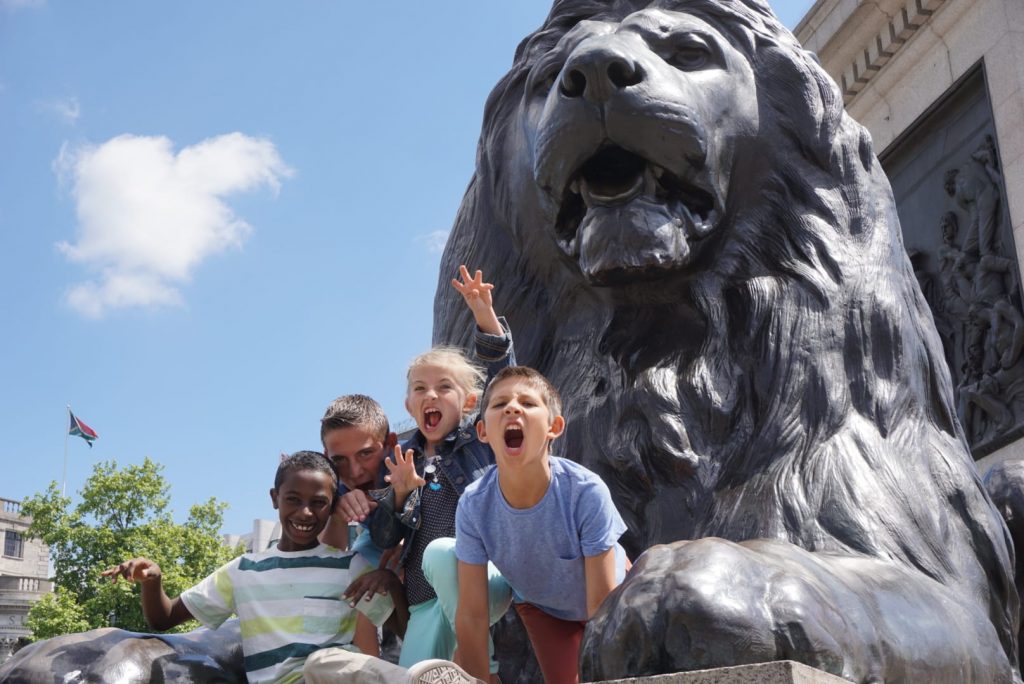 Kids growling on the Lions statues in Trafalgar Square | London with Kids | Global Munchkins