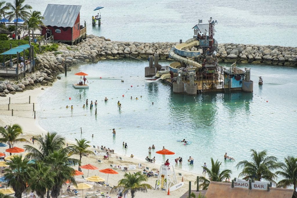 Guests slide and splash on Pelican Plunge, an exciting water play area located within swimming distance from the shore at Castaway Cay. The 2,400-square-foot floating platform has two water slides—an enclosed corkscrew slide and a 140-foot-long open slide—that take guests on a twisting ride, ending with a splash into the lagoon. A giant "bucket dump" and water cannons soak guests on the platform. (Matt Stroshane, photographer)