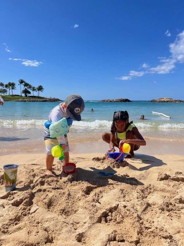 two kids playing on the beach near Disney's Aulani