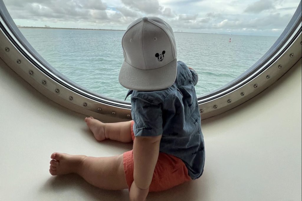 toddler looking out cruise window