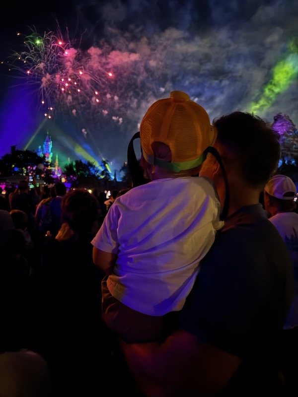 dad and toddler watching fireworks on Main St